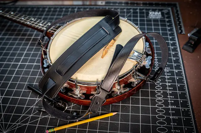 A black leather strap on a banjo